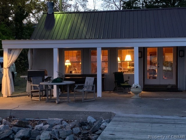 1167 Johns Neck Road Weems, VA 22576 - Photo 7 of 48 a backyard of a house with barbeque oven table and chairs