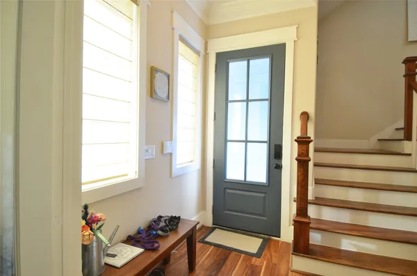 a kitchen with granite countertop wooden floors a center island and stainless steel appliances