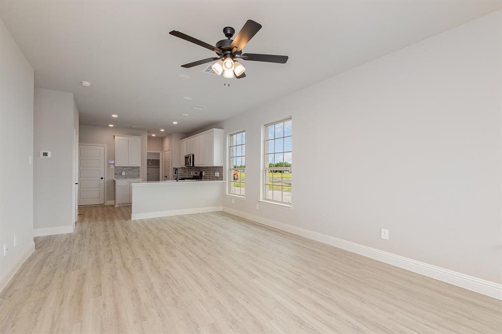 3613 Geoffrey Trail Rowlett, TX 75088 - Photo 3 of 13 Unfurnished living room featuring light wood-type flooring, ceiling fan, and recessed lighting