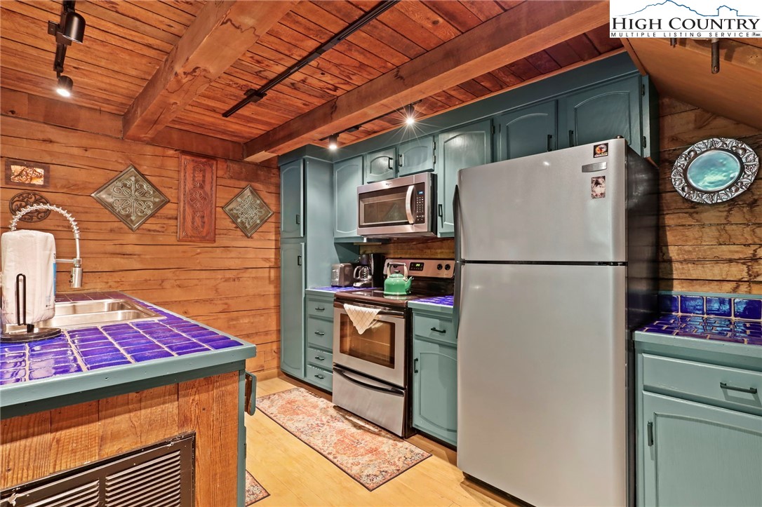 148 Estates Drive Boone, NC 28607 - Photo 2 of 16 a kitchen with stainless steel appliances granite countertop a refrigerator and a stove