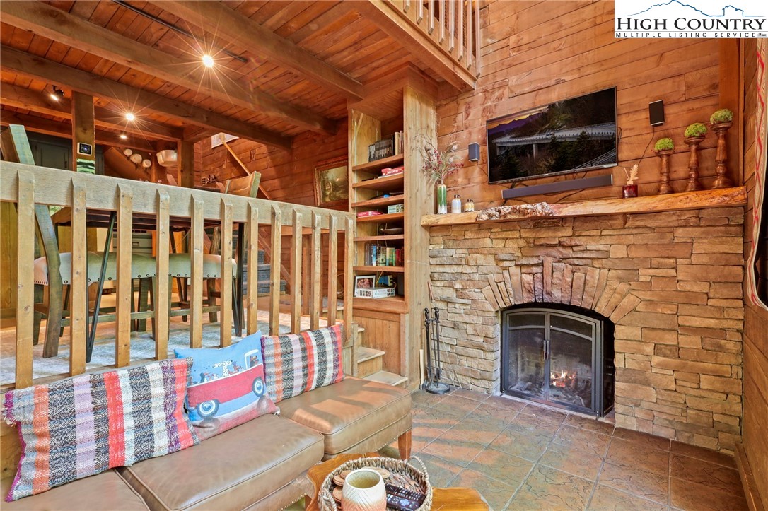148 Estates Drive Boone, NC 28607 - Photo 4 of 16 a living room with fireplace furniture and a flat screen tv