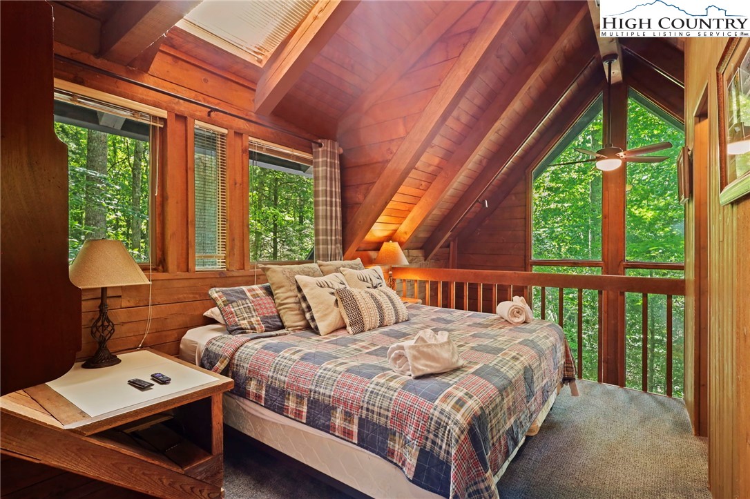 148 Estates Drive Boone, NC 28607 - Photo 8 of 16 a bedroom with a bed and a large window