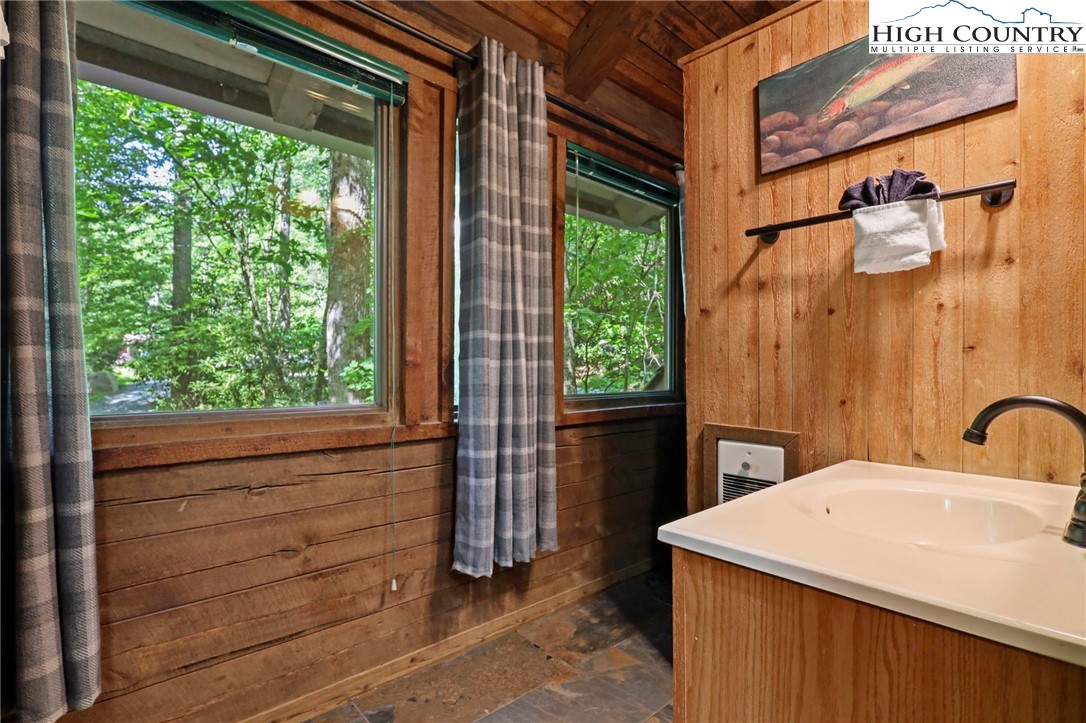 148 Estates Drive Boone, NC 28607 - Photo 9 of 16 a bathroom with a sink and a large mirror