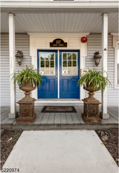 117 Main Street, Unit 1 Andover, NJ 07821 - Photo 2 of 11 a front view of a house with potted plants