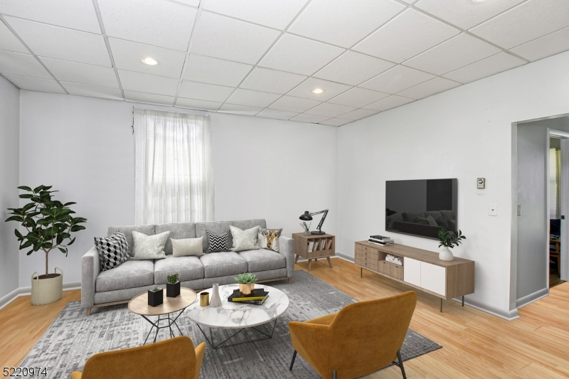 117 Main Street, Unit 1 Andover, NJ 07821 - Photo 3 of 11 a living room with furniture and a flat screen tv