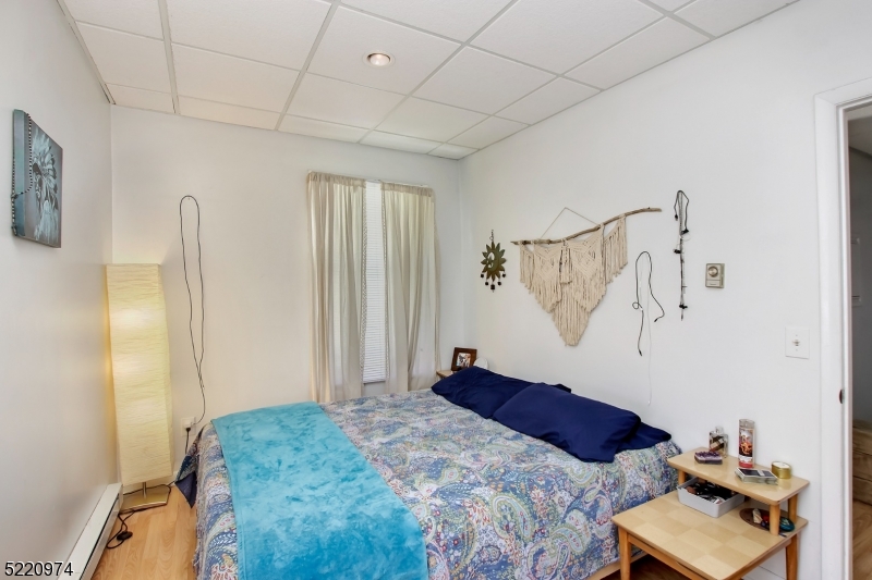 117 Main Street, Unit 1 Andover, NJ 07821 - Photo 5 of 11 a bedroom with a bed and a window