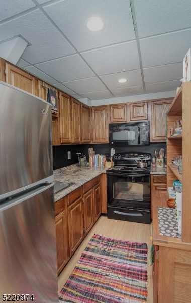 117 Main Street, Unit 1 Andover, NJ 07821 - Photo 6 of 11 a kitchen with stainless steel appliances granite countertop a stove a sink and a microwave