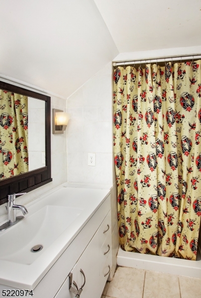 117 Main Street, Unit 1 Andover, NJ 07821 - Photo 7 of 11 a bathroom with a sink and a mirror