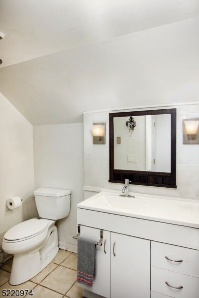 117 Main Street, Unit 1 Andover, NJ 07821 - Photo 8 of 11 a bathroom with a sink and a mirror
