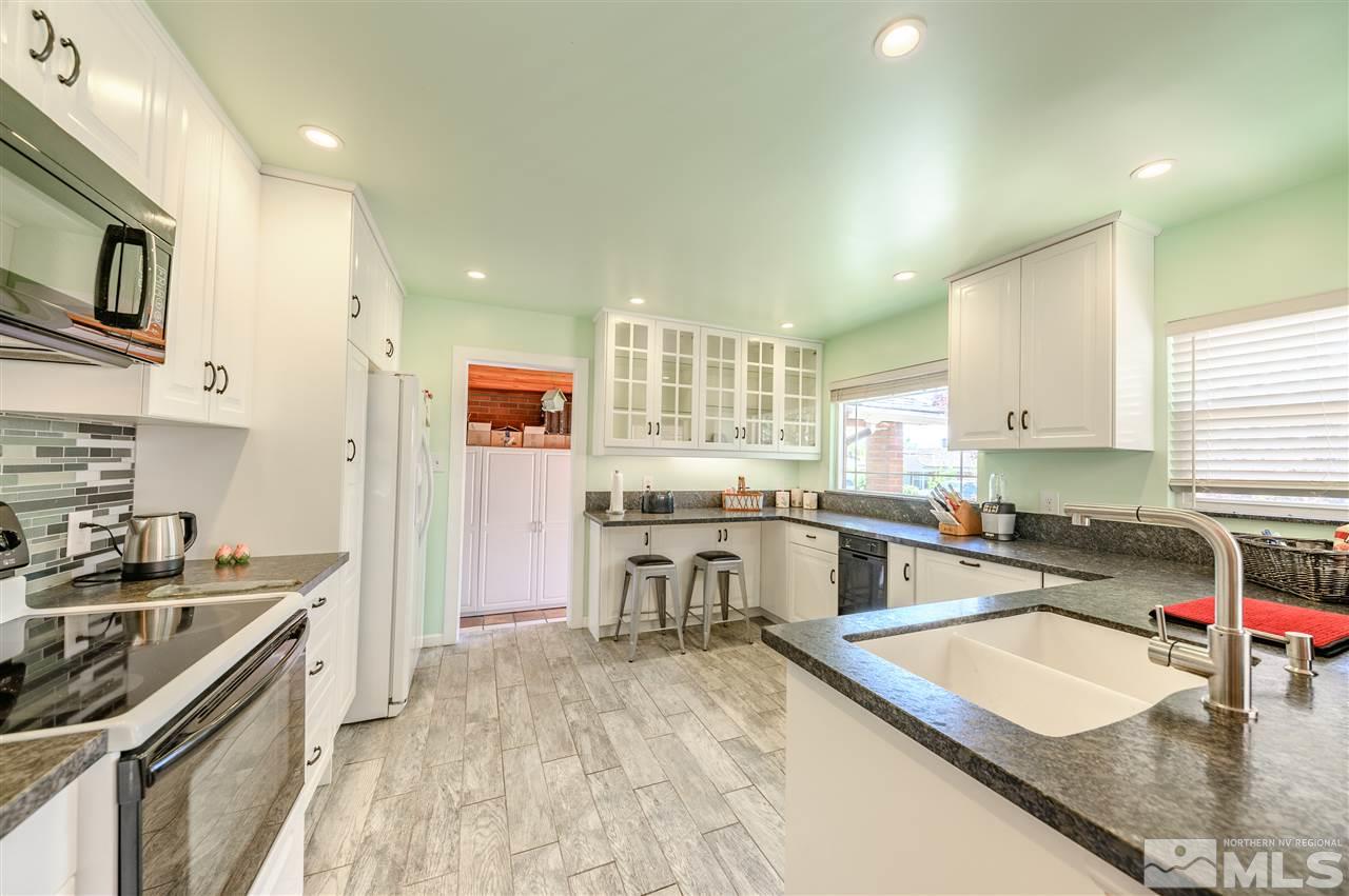 705 East Taylor Street Reno, NV 89502 - Photo 6 of 20 a kitchen with stainless steel appliances granite countertop a sink stove and refrigerator