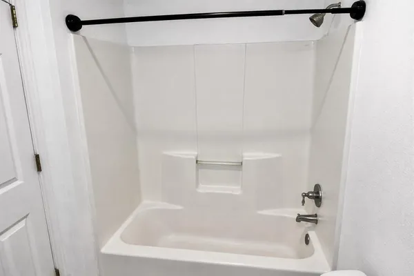 a bathroom with a shower and a bath tub