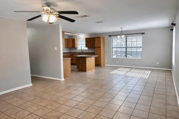 a view of kitchen with granite countertop cabinets and window