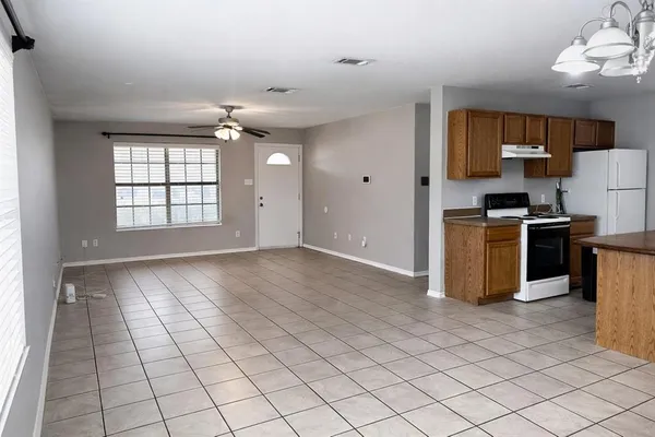 a view of a kitchen with microwave and cabinets