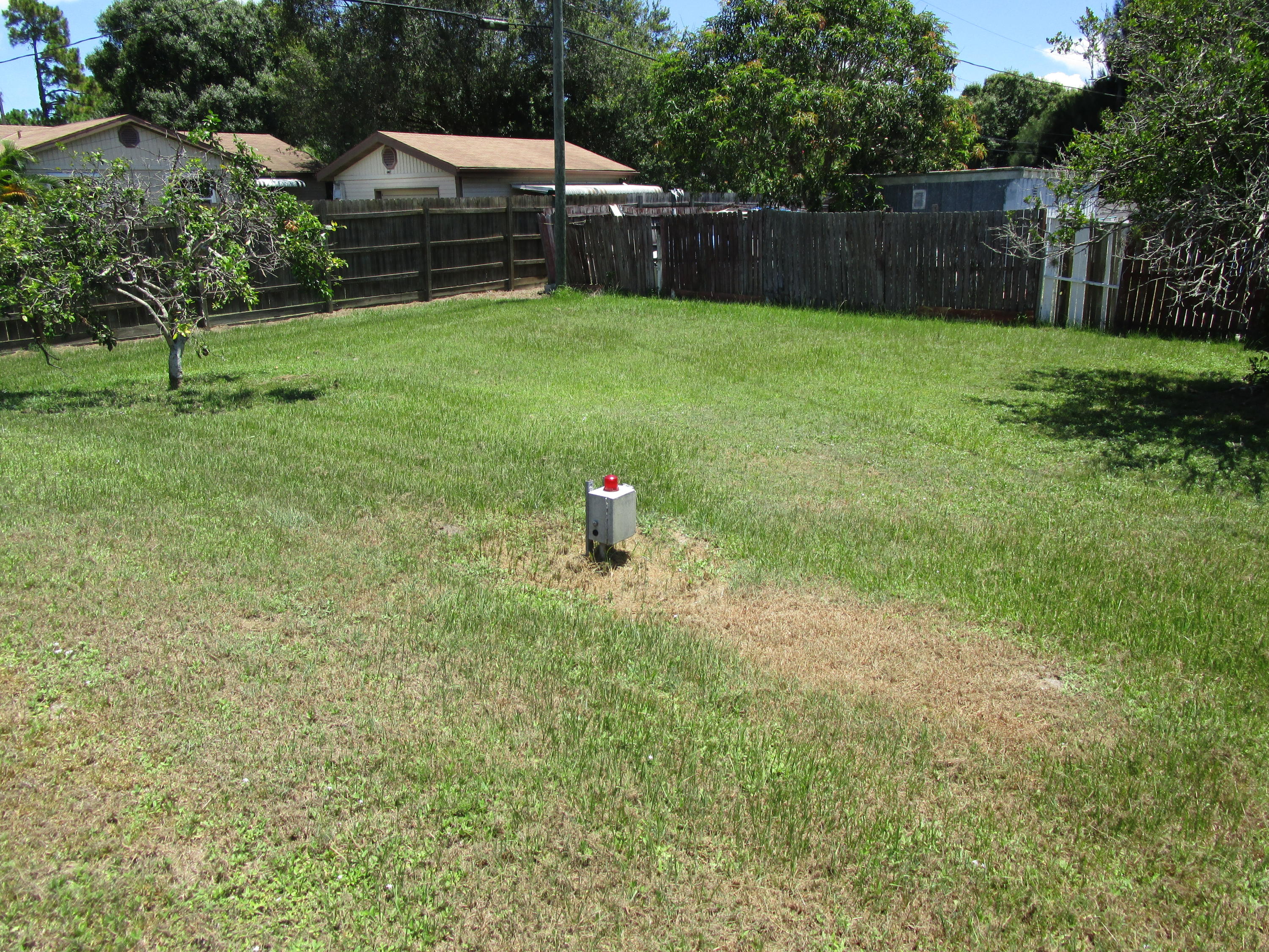 6302 Indrio Road Fort Pierce, FL 34951 - Photo 15 of 25 a backyard of a house with lots of green space