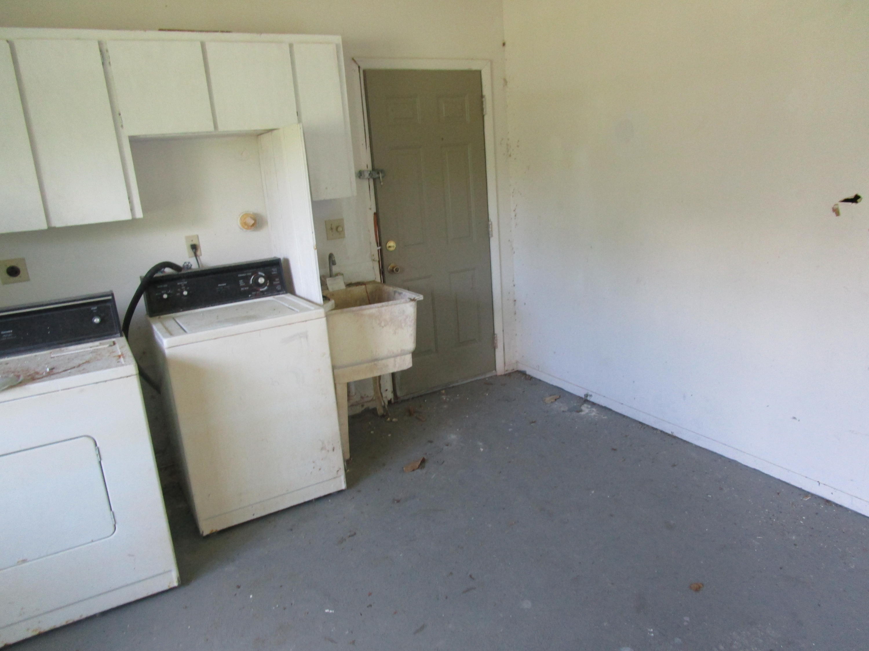 6302 Indrio Road Fort Pierce, FL 34951 - Photo 19 of 25 a view of storage and utility room with washer and dryer