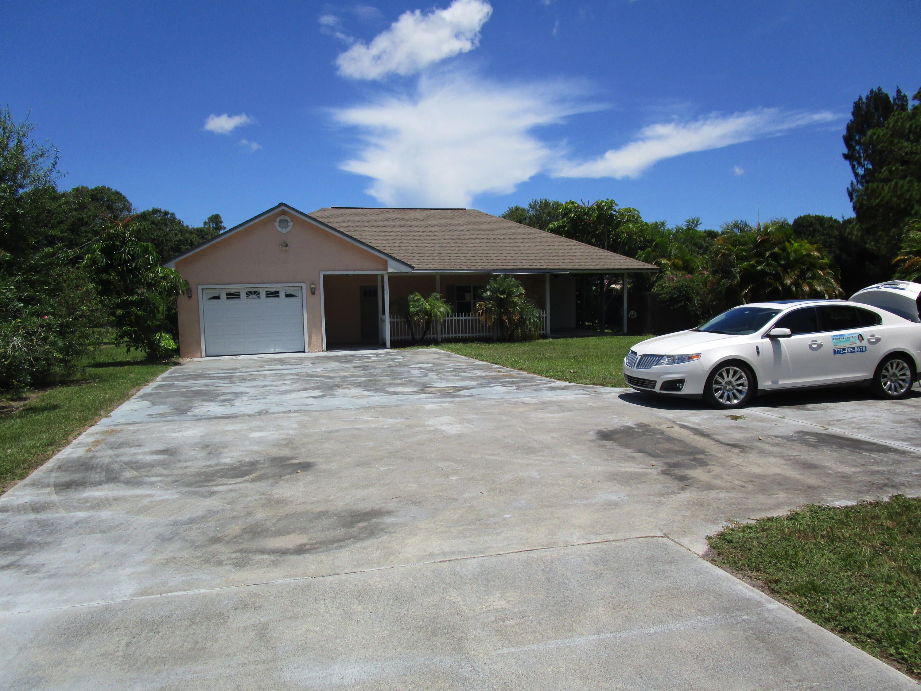 6302 Indrio Road Fort Pierce, FL 34951 - Photo 25 of 25 a front view of a house with a garden