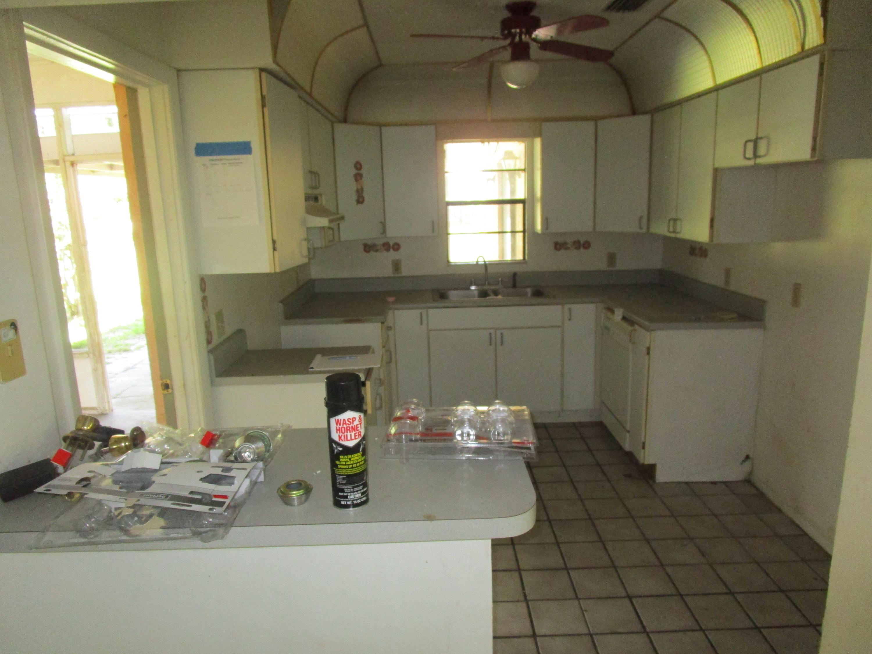 6302 Indrio Road Fort Pierce, FL 34951 - Photo 3 of 25 a kitchen with a sink and a refrigerator