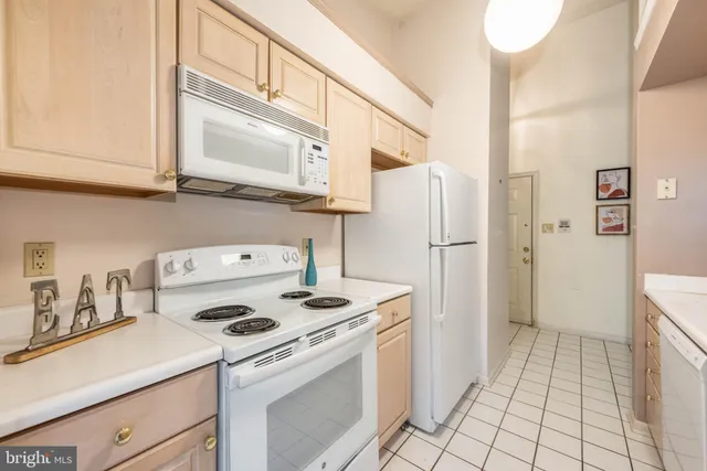 a kitchen with a stove top oven and refrigerator