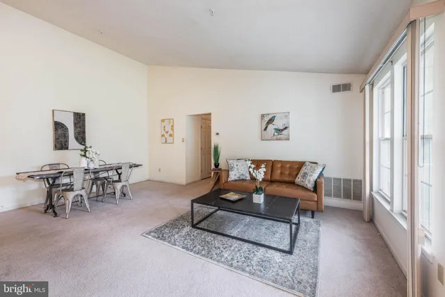 a living room with furniture and a large window