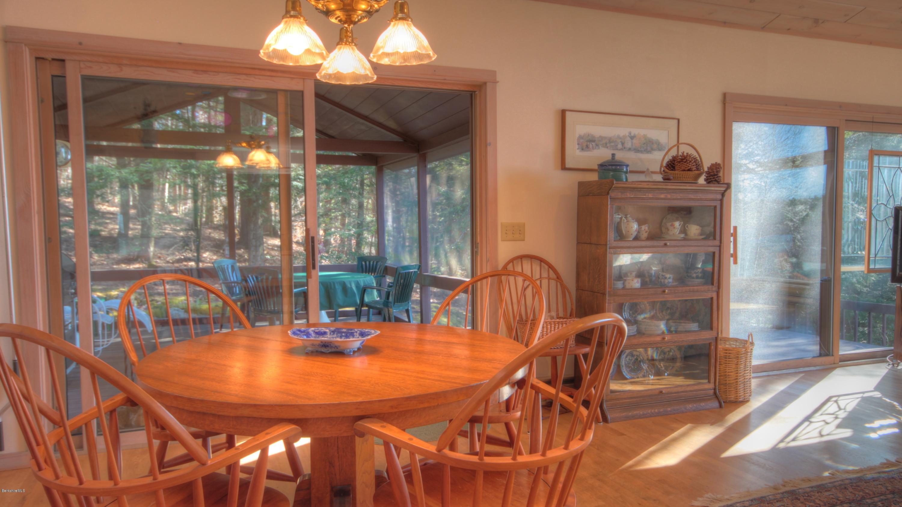 75 Laurel Hill Road Monterey, MA 01245 - Photo 11 of 25 a dining room with glass top table and chairs