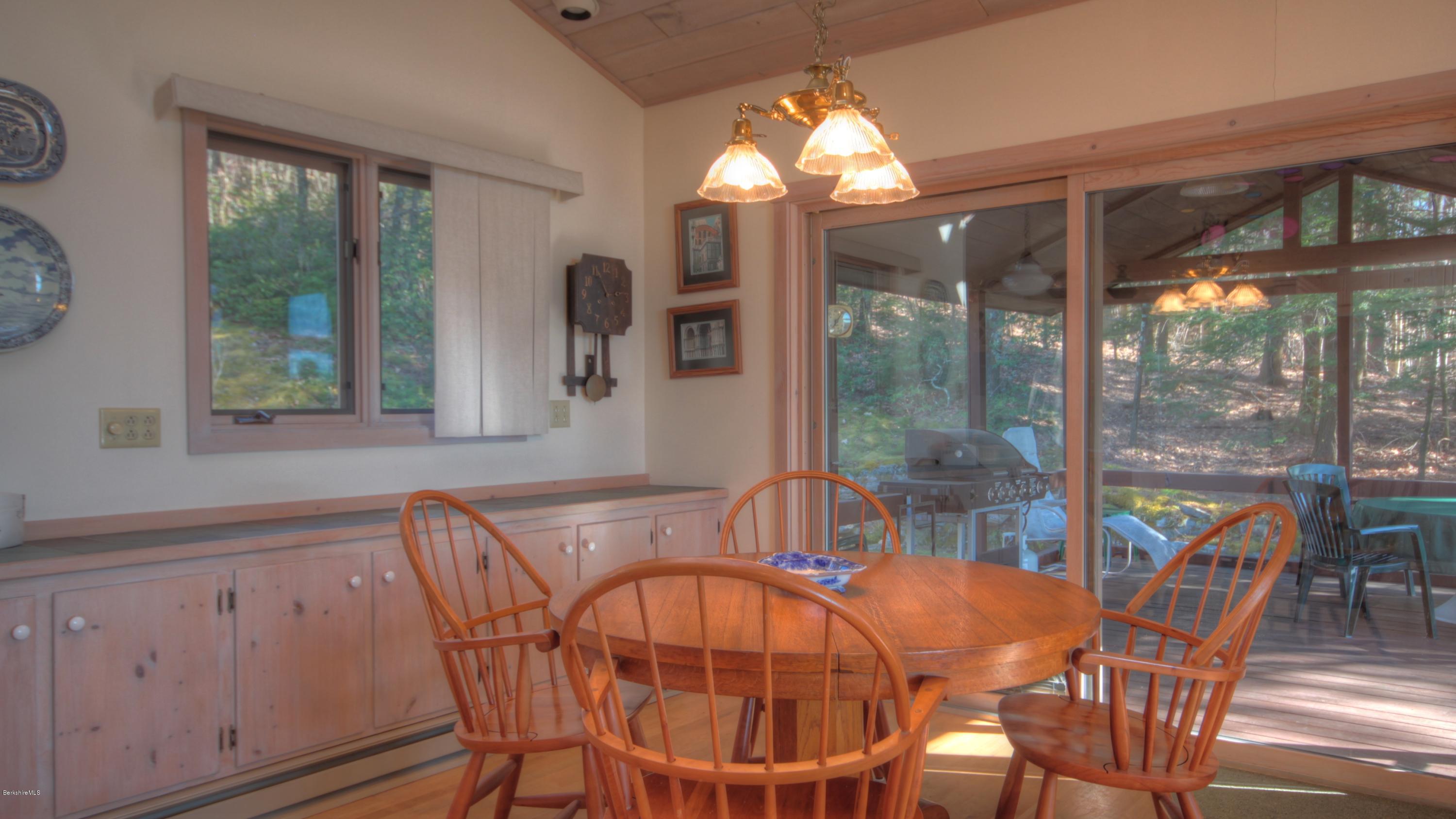 75 Laurel Hill Road Monterey, MA 01245 - Photo 12 of 25 a dining room with furniture a chandelier and wooden floor