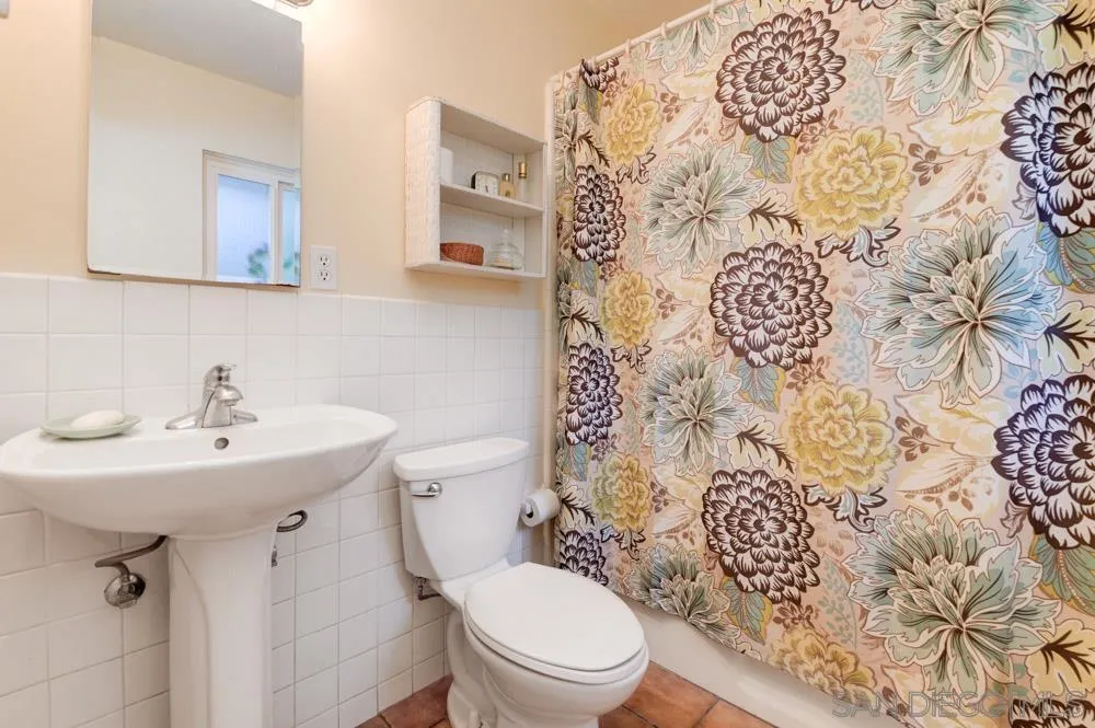 4470 Monahan Road La Mesa, CA 91941 - Photo 14 of 26 a bathroom with a sink and mirror with toilet