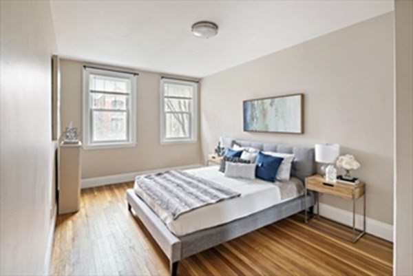 52 Strathmore Road, Unit 25 Boston, MA 02135 - Photo 9 of 12 a bedroom with a bed and wooden floor