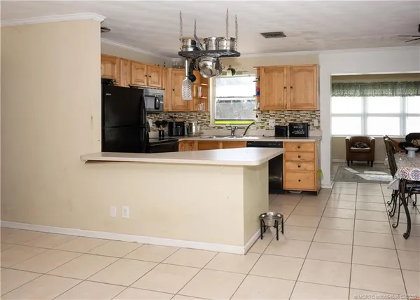 a kitchen with a sink cabinets and window