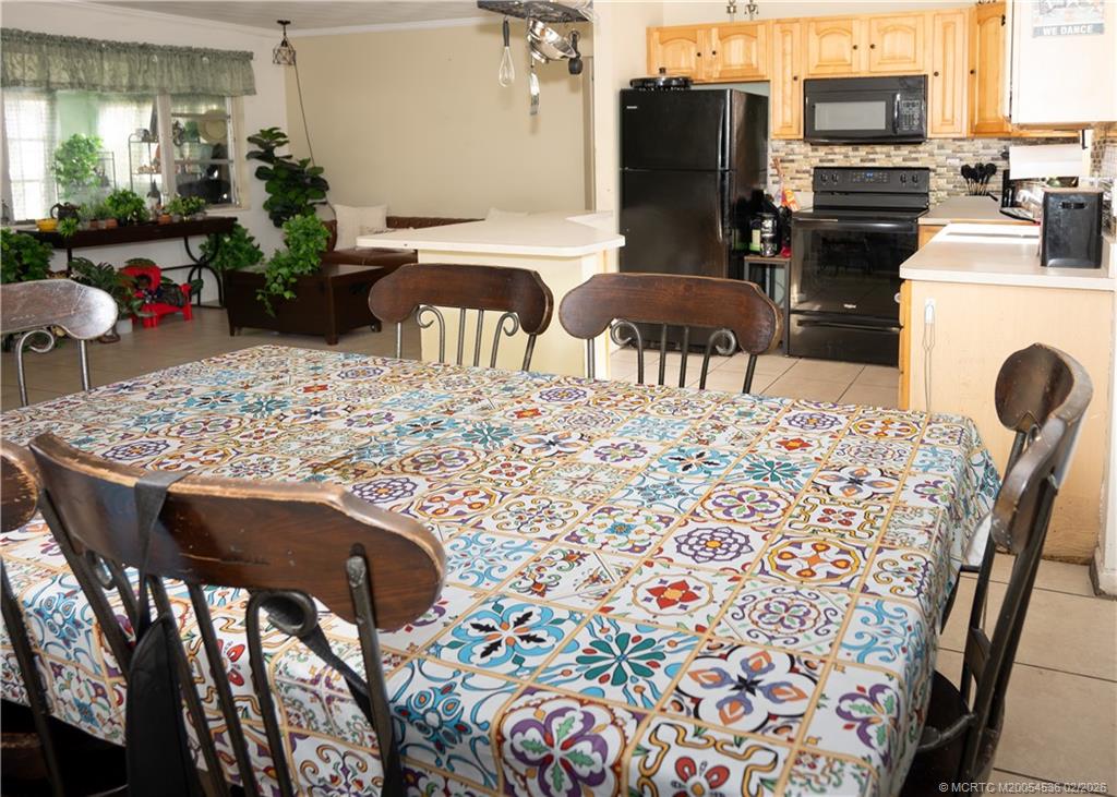 2314 Southeast Washington Street Stuart, FL 34997 - Photo 12 of 16 a view of a dining room with furniture and a fireplace