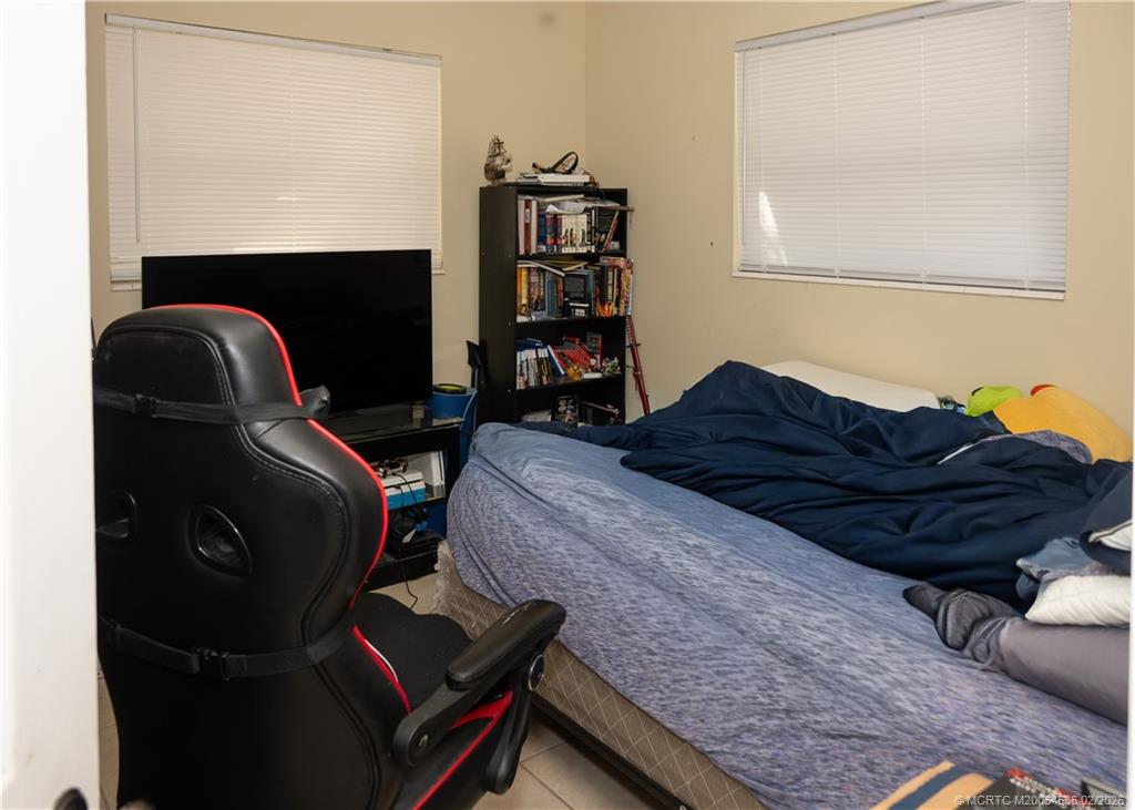 2314 Southeast Washington Street Stuart, FL 34997 - Photo 15 of 16 a bedroom with a bed and dresser