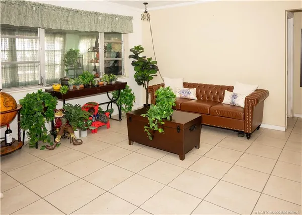 a living room with furniture and flowers