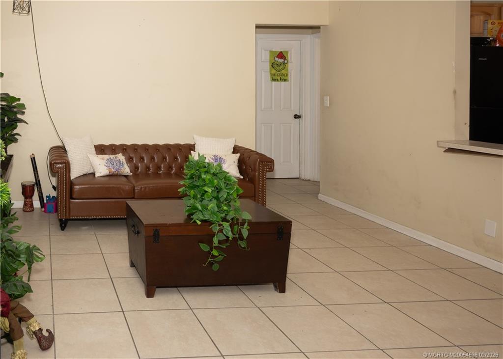 2314 Southeast Washington Street Stuart, FL 34997 - Photo 3 of 16 a living room with furniture and a flat screen tv