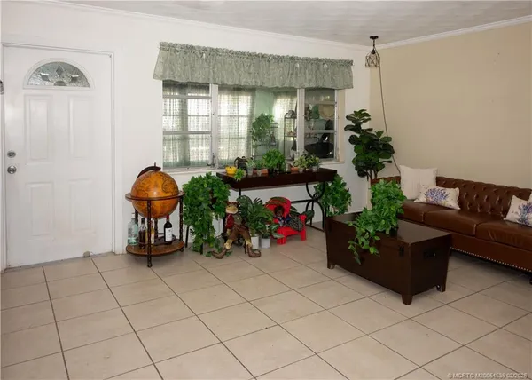 a living room with furniture and flowers