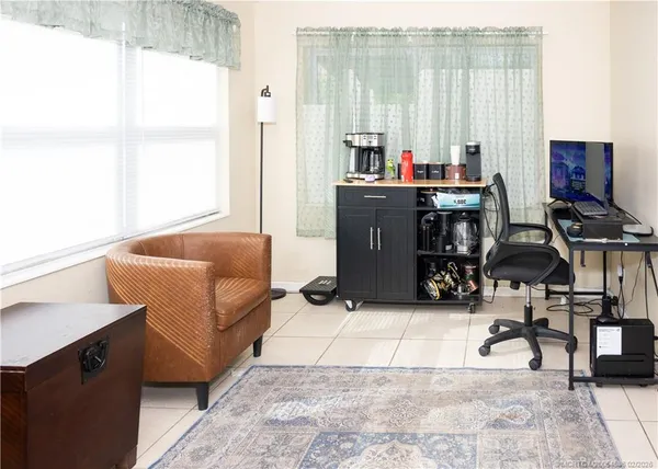 a living room with furniture a window and a flat screen tv
