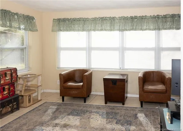 a living room with furniture and a floor to ceiling window
