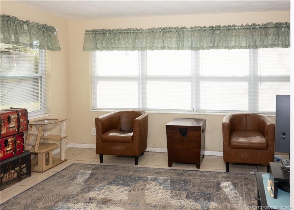 2314 Southeast Washington Street Stuart, FL 34997 - Photo 7 of 16 a living room with furniture and a floor to ceiling window
