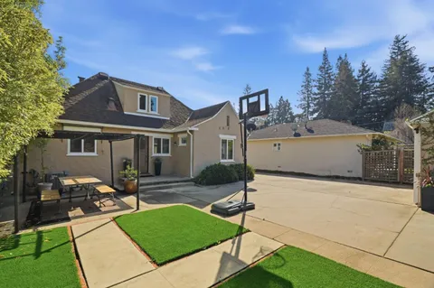 a front view of house with yard and outdoor seating