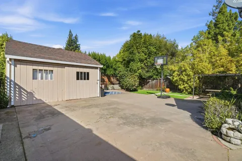 front view of a house with a yard and potted plants