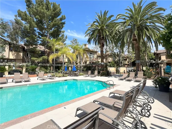 a view of swimming pool with outdoor seating and a patio