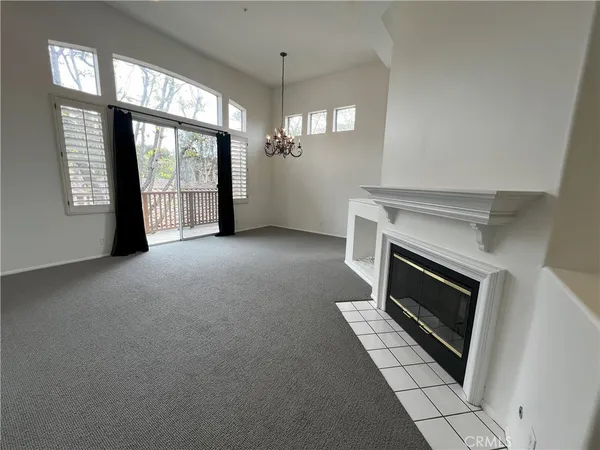 a view of a livingroom with an empty space and a fireplace