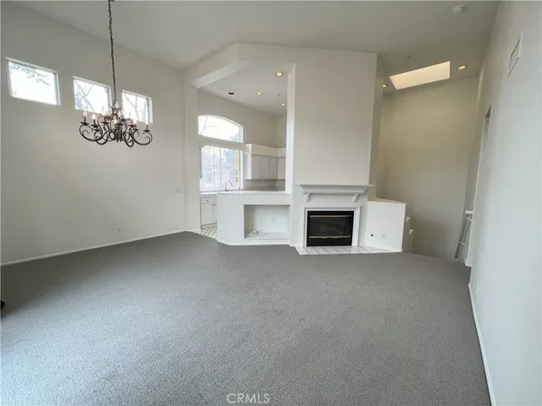 a view of empty room with a fireplace