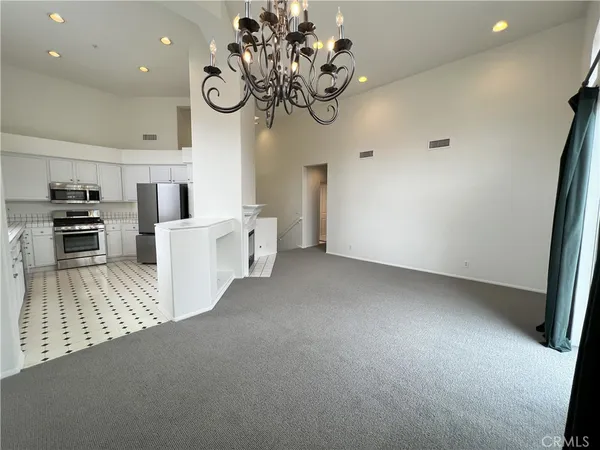 a view of a kitchen with a sink cabinets and wooden floor
