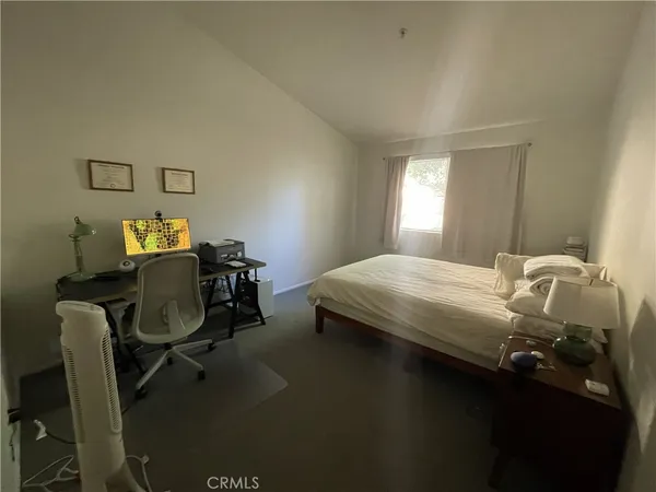 a bedroom with a bed chair and window