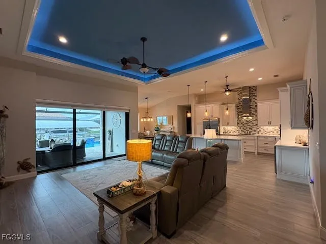 a kitchen with kitchen island a counter top space a sink stainless steel appliances and cabinets