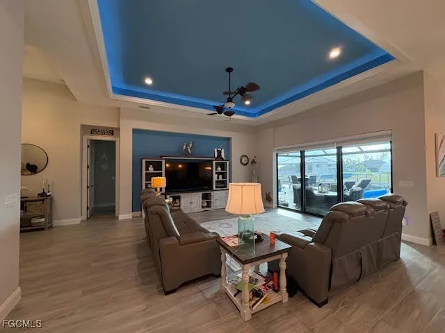 a kitchen with stainless steel appliances a dining table chairs and a refrigerator