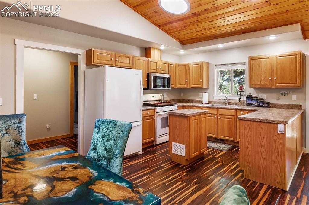 234 Wahsatch Road Florissant, CO 80816 - Photo 14 of 44 a kitchen with stainless steel appliances granite countertop a stove a sink and a refrigerator