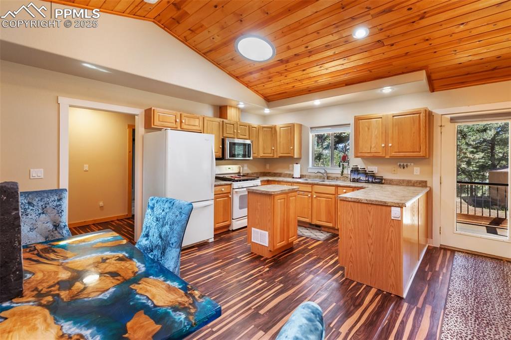 234 Wahsatch Road Florissant, CO 80816 - Photo 18 of 44 a kitchen with stainless steel appliances granite countertop a refrigerator a sink dishwasher a stove and white countertops with wooden floor