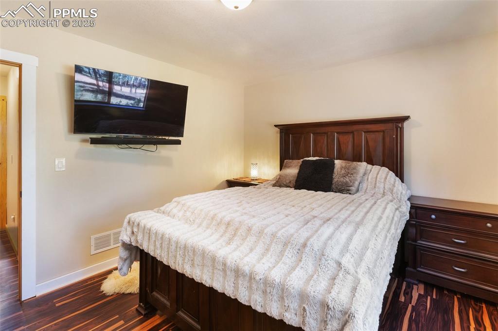 234 Wahsatch Road Florissant, CO 80816 - Photo 20 of 44 a bedroom with a bed and a flat screen tv