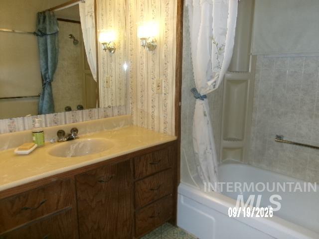 31997 2nd Fork Road Ola, ID 83657 - Photo 16 of 47 Bathroom featuring a vanity with a single basin sink, wall-mounted sconces, and a shower-tub combination