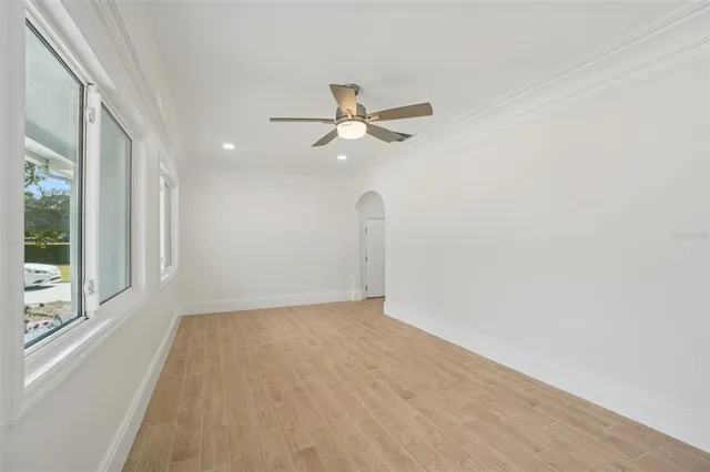 wooden floor in an empty room with a window